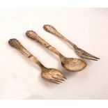 A Georg Jensen lily of the valley pattern serving spoon and fork and a fork with two tines,