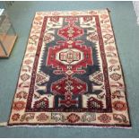 An Ardabil rug, the grey ground with red central medallion to an ivory border,
