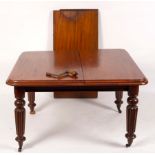 A Victorian mahogany extending table on tapering fluted legs, with extra leaf and winder,