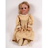A Simon & Halbig 34, for Kammer Reinhart bisque head doll with sleepy eyes, open mouth with teeth,
