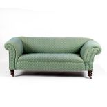 A Victorian Chesterfield sofa, the scroll arms with single drop end, green foliate upholstery,