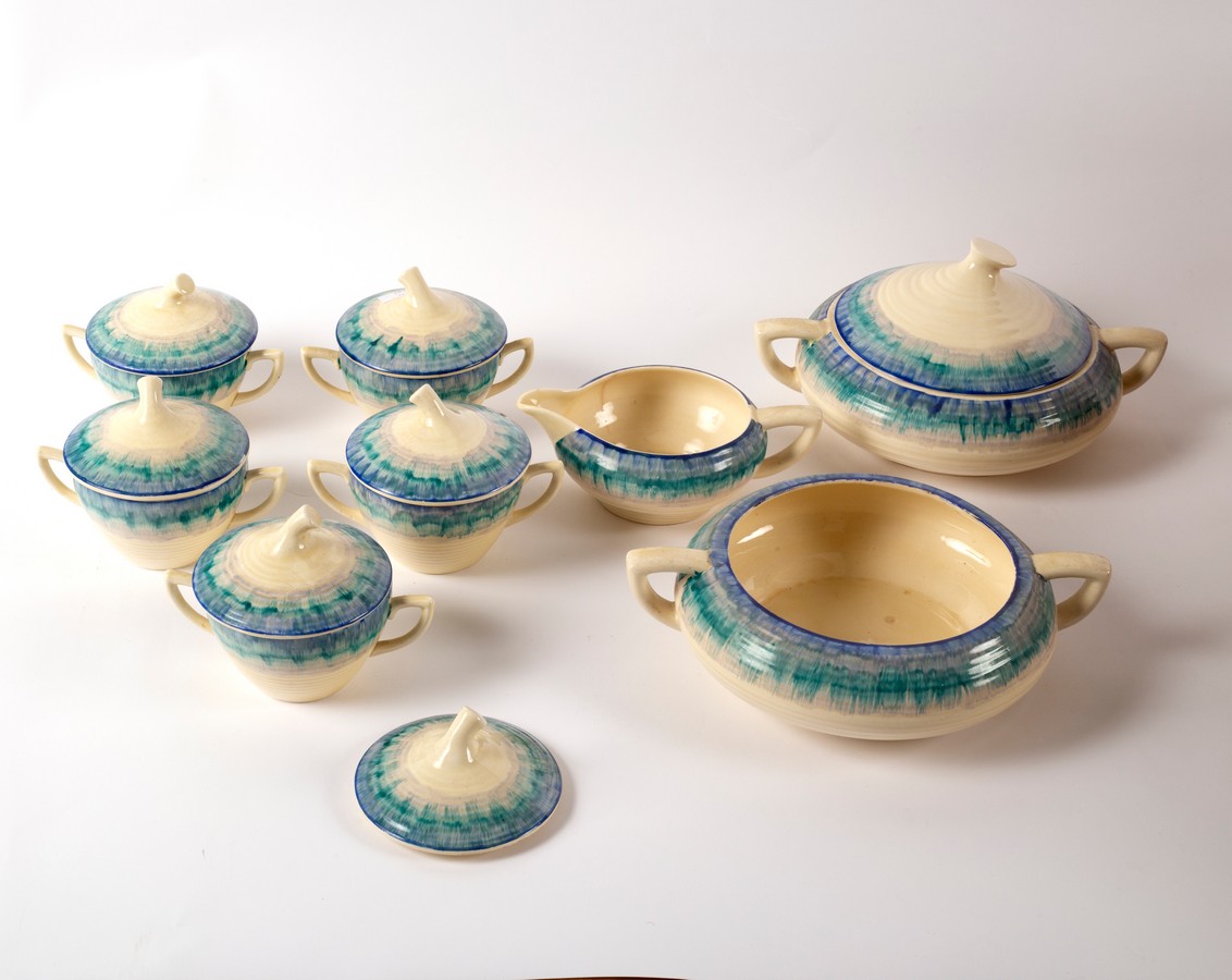 A Clarice Cliff part dinner service in the Bizarre Aura pattern, Wilkinson and Son,