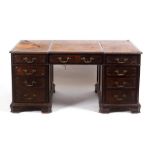 A 19th Century pedestal desk, with inset leather top, fitted a surround of nine drawers,