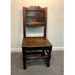 An oak side chair with panel back, circa 1700, with shaped cresting rail, 99cm high, 45cm wide,