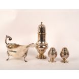 A George III style silver sauceboat, London 1911, a silver sugar caster,