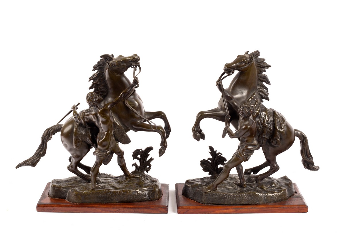 After Guillaume Coustou/a pair of bronze models of the Marly Horses/on wood plinths,