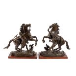 After Guillaume Coustou/a pair of bronze models of the Marly Horses/on wood plinths,