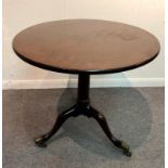 A George II mahogany tripod table, circa 1750, the circular top on a birdcage support,