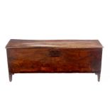 An 18th Century oak chest of narrow proportion, the top with moulded border and steel strap hinges,