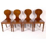 A set of four mahogany Regency oak hall chairs