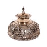 An Edwardian silver inkwell, William Comyns, London 1904, the hinged cover with cone finial,