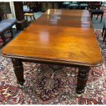 A late 19th Century mahogany wind-out dining table with three extra leaves (two matched) on turned