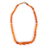 A Baltic amber necklace of graduated oval beads, approximately 11.