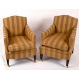 A pair of armchairs upholstered in striped gold fabric,