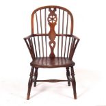 A stick and pierced splat back armchair with solid elm seat,