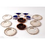 A pair of silver plated oval salts with pierced decoration and blue glass liners, 8cm wide,