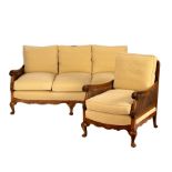 A bergère three-seater maple sofa and matching chair,