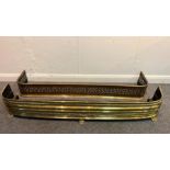A pierced brass fire curb, 133cm wide and another on paw feet,