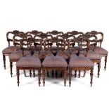 A set of twelve William IV rosewood dining chairs with scrolling acanthus carved backs and splats,