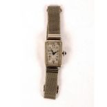 A lady's 18k white gold cased wristwatch, the rectangular silvered dial with Arabic numerals,