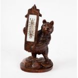 A Black Forest carved thermometer stand of bear form, modelled standing, 29.