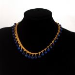 An Archaeological revival gold and lapis lazuli fringe necklace, circa 1870,