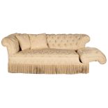 A button back Chesterfield sofa upholstered in cream damask with a fringed border on square