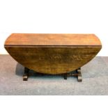 A 17th Century style oak gateleg table on a ball turned underframe,