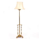 An early 20th Century brass telescopic standard lamp with triple-column base CONDITION