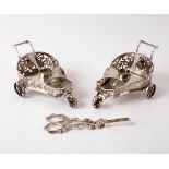 A pair of plated novelty cruet stands modelled as chariots, retailed by Carrington, 130 Regent St,
