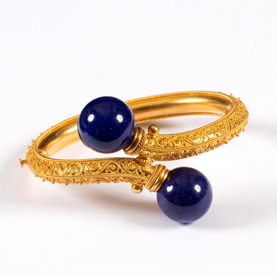 An Archaeological revival gold and lapis lazuli bangle, circa 1870,