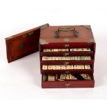 A Chinese Mah Jong set in a metal mounted wooden case,