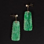 A pair of carved jade ear pendants,