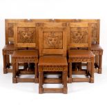 A set of eight 17th Century style oak dining chairs with armorials to the panel backs,