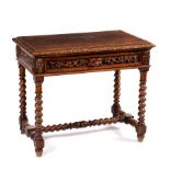 An oak side table, the moulded top above a frieze drawer carved scrolling foliage and a lion's mask,