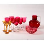A quantity of cranberry glass and three amber tinted cordial glasses CONDITION REPORT:
