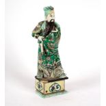 A Chinese famille verte figure of a bearded man, 19th Century, on a square plinth, 29.