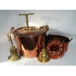 A two-handled copper pan with lid, two door stops, a jelly mould, a trivet pot and cover,