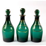 A set of three 20th Century green glass spirit decanters and stoppers, named in gilt Rum,