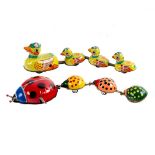 A tinplate duck with three linked ducklings, 28cm long and a ladybird and three babies, 28cm long,