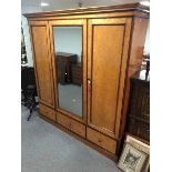 A large Victorian satinwood wardrobe by Holland & Sons,
