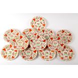 A set of twelve English porcelain dessert plates, circa 1810, probably Coalport, painted in red,