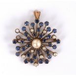 A sapphire and pearl starburst pendant, centred by a large,