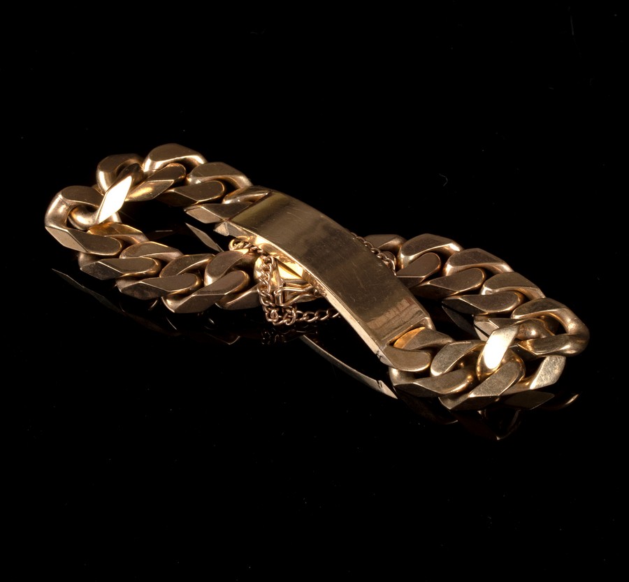 A gentleman's 9ct gold bracelet of flattened curb links with central rectangular plaque,