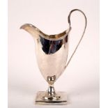 A George III silver helmet-shaped cream jug, Hester Bateman, London 1788, 18cm high,