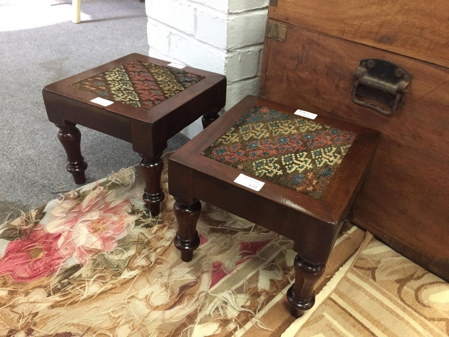 A pair of William IV stools with inset needlework tops on bun feet,