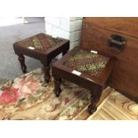 A pair of William IV stools with inset needlework tops on bun feet,