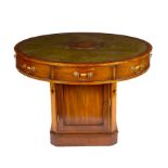 A mahogany drum-shaped rent table, circa 1920,