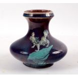 A Chinese flambe glaze vase, Qing dynasty, decorated a Fo Dog on turquoise rockwork in enamels, 12.