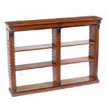 A Regency oak bookcase with adjustable shelves and cluster columns with ebonised finials,